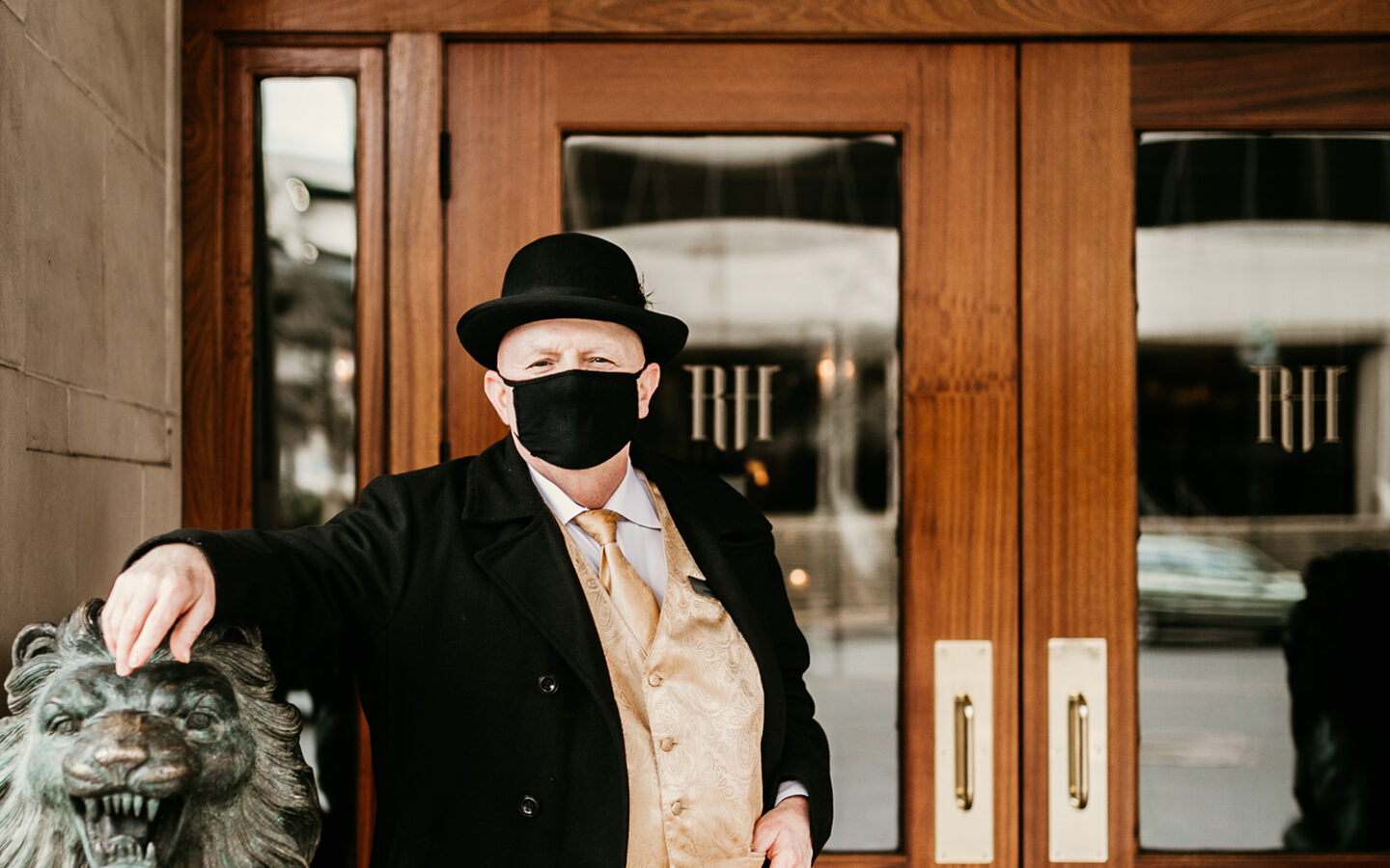 read house bellman wearing facemask at front entrance of hotel
