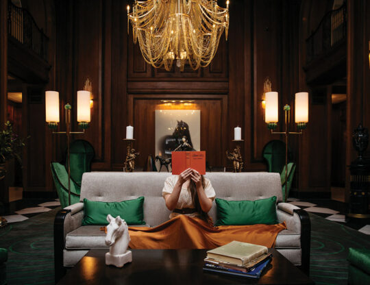 Women reading book on a couch