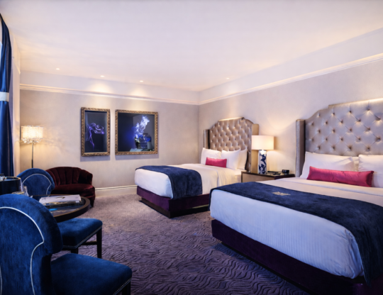 a hotel room with two queen beds