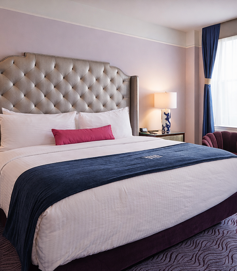 a hotel room with a king bed