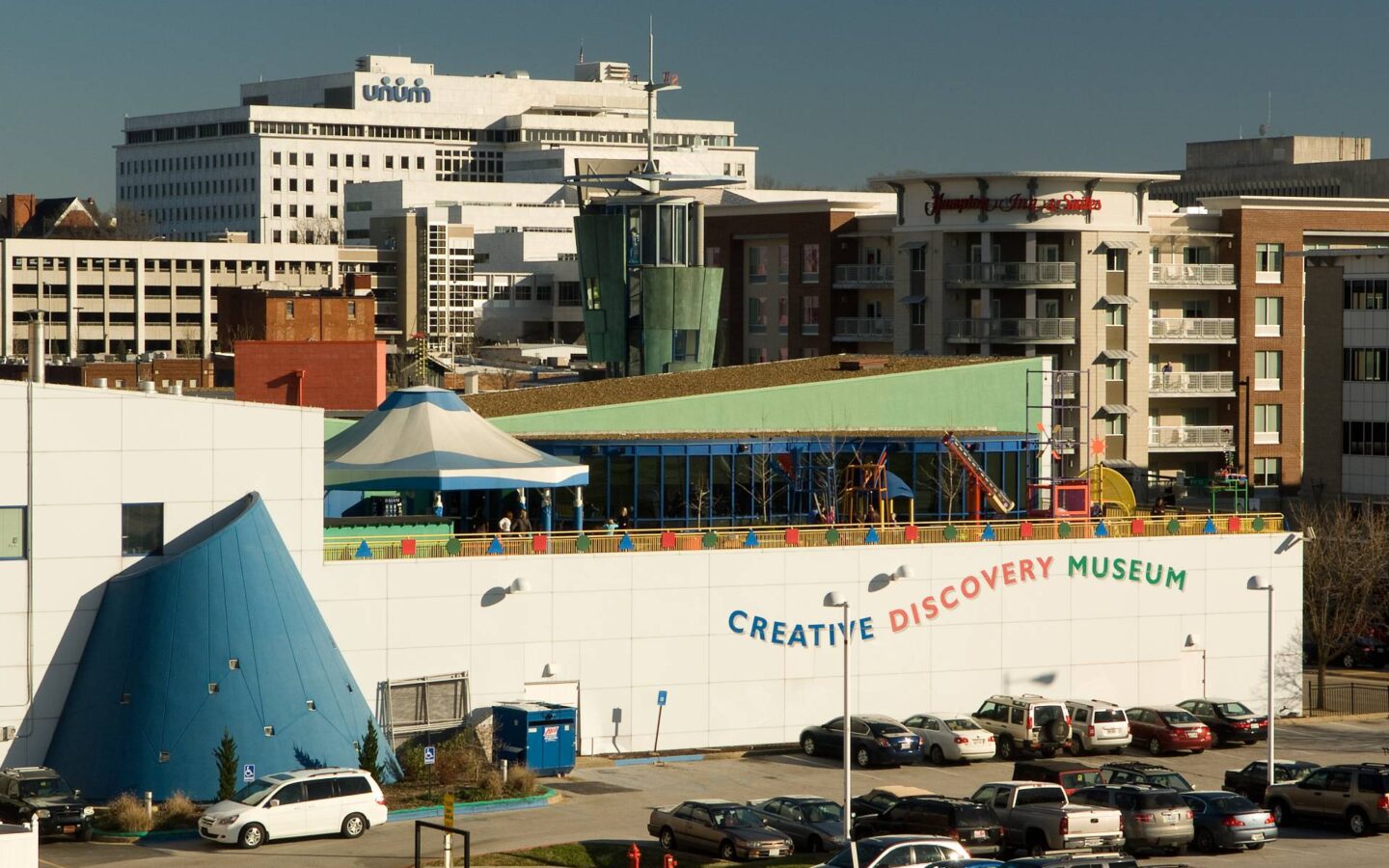 view of the creative discovery museum from across a car park